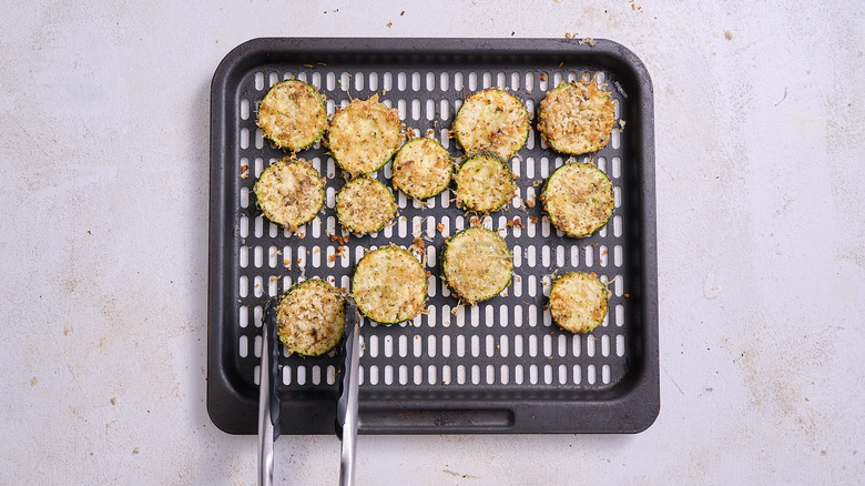 flipping zucchini using tongs