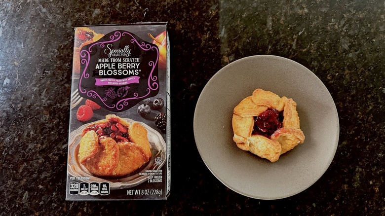 Overhead view of box of Aldi Apple Berry Blossoms and a pastry on a plate.