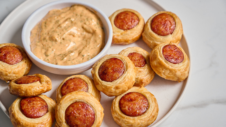 andouille sausage puffs with a bowl of remoulade on a table