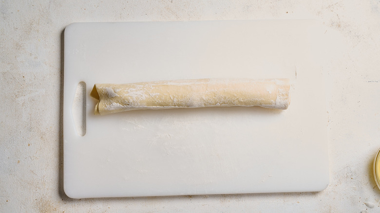 Puff pastry log on cutting board
