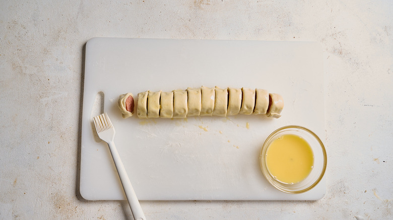 brushing puff pastry pieces with egg wash