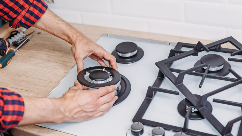Person installing gas hob stove