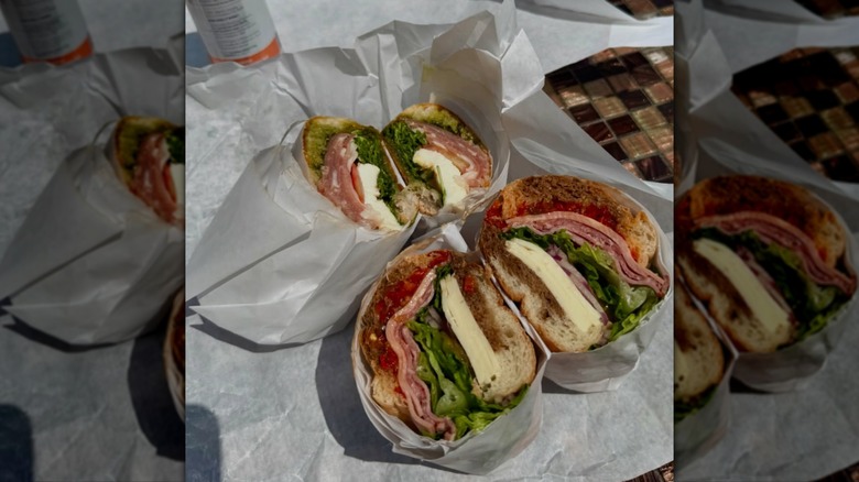 Two DeLuca's sandwiches in parchment paper