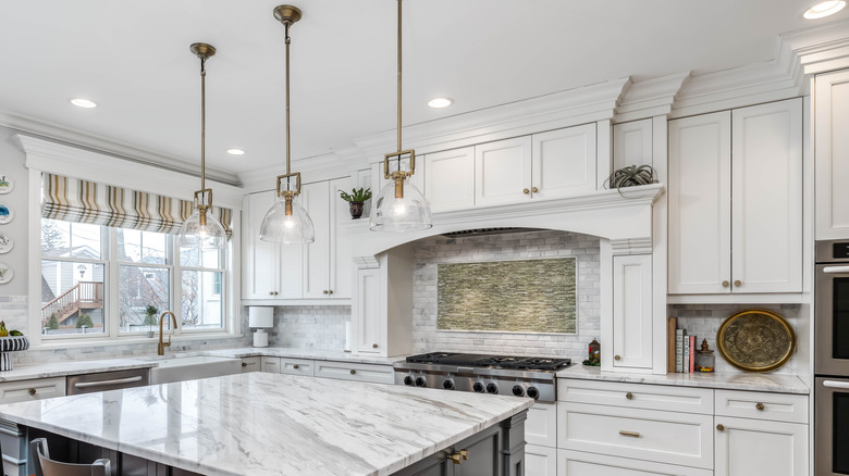 A modern farmhouse kitchen with decorative molding on kitchen cabinets