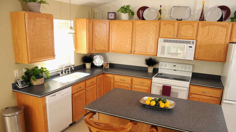 Kitchen with plates stored on top of cabinets