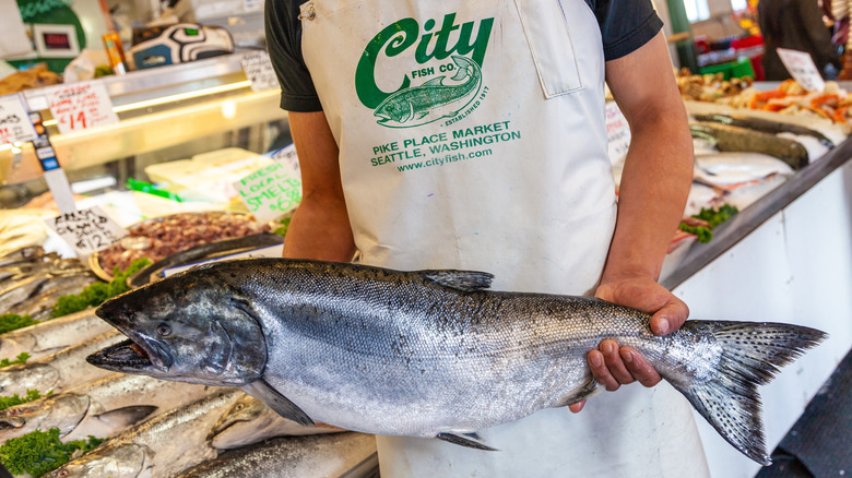Pike Place Market worker holding salmon