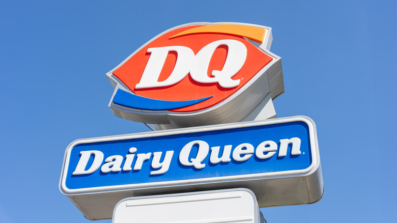 Dairy Queen sign against blue sky background