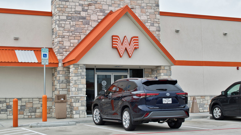 Front of Whataburger restaurant with car outside in parking lot