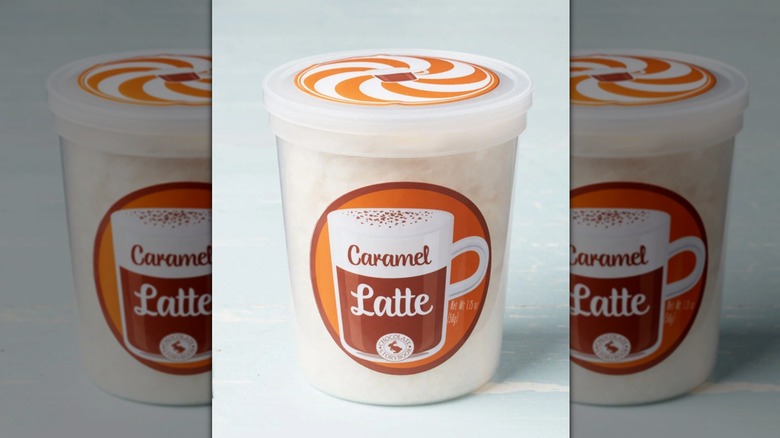 tub of caramel latte cotton candy on blue background, mirrored image