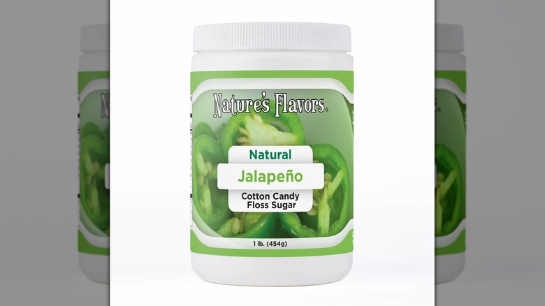 tub of jalapeño cotton candy sugar on white background, mirrored image