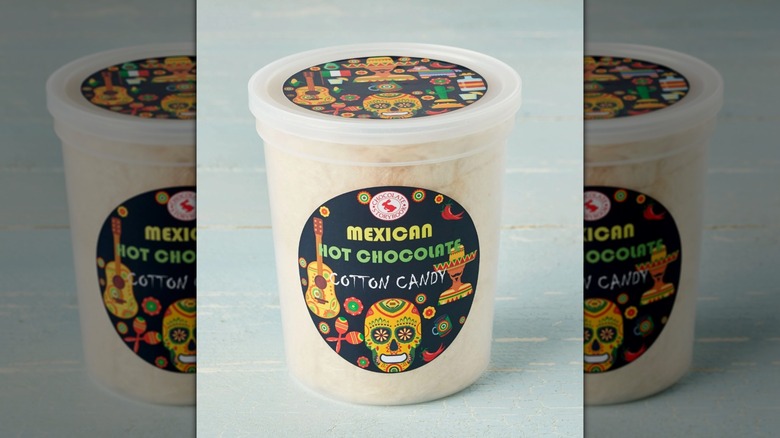 tub of Mexican hot chocolate cotton candy on blue background, mirrored image