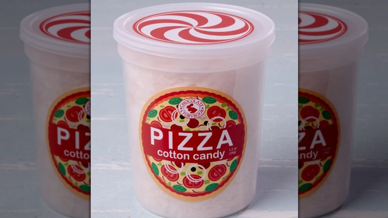 tub of pizza cotton candy on blue background, mirrored image