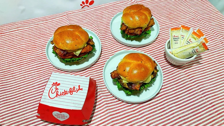 Chick-Fil-A jalapeño ranch club chicken sandwiches on a table with a bowl of sauces