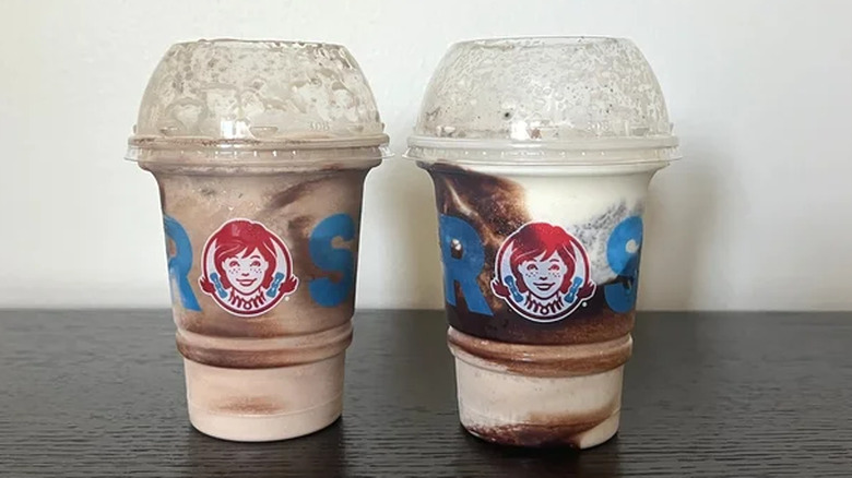 Two cups of Wendy's Cookie Doug Frosty Fusion