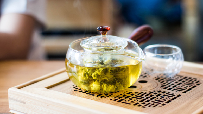 brewing crysanthemum tea in glass teapot