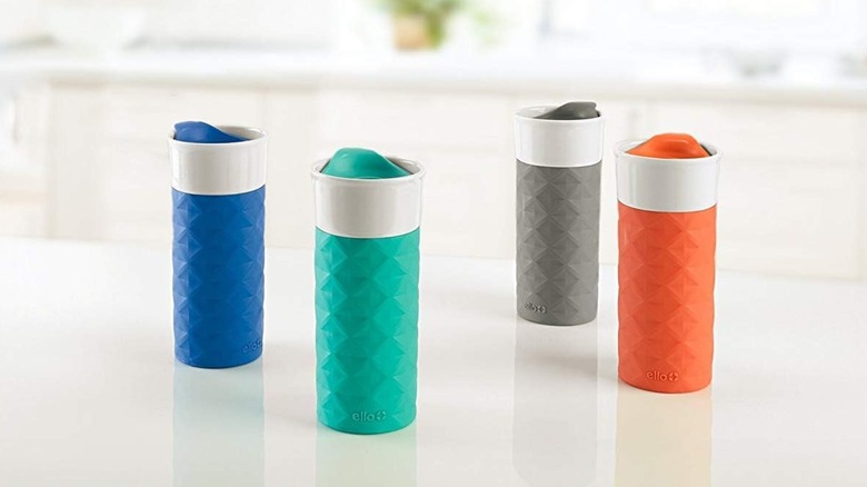 Four Ello Ogden Ceramic Travel Mugs on a counter in blue, teal, gray, and orange
