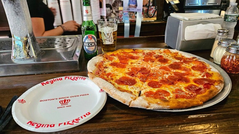 Pepperoni pizza on silver tray on bar