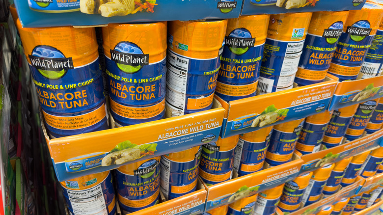 Orange and blue packs of Wild Planet tuna stacked in the store