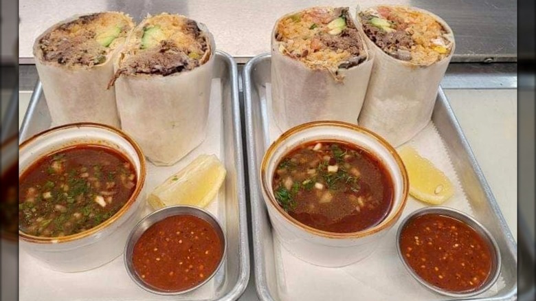 Two trays with burritos and salsa