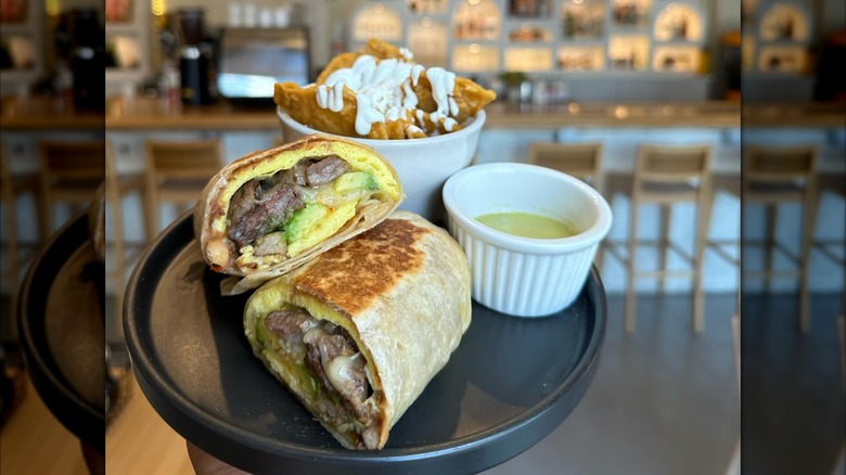 breakfast burrito on plate with chilaquiles