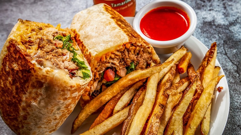 Steak burrito with fries and sauce