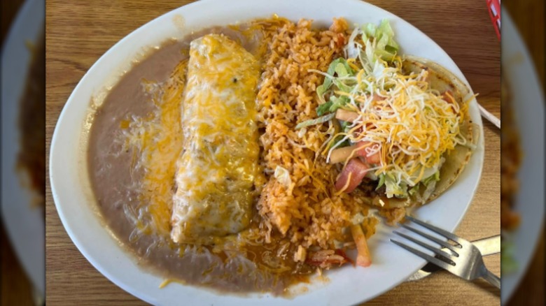 Plate with beans, burrito, rice, lettuce, and cheese