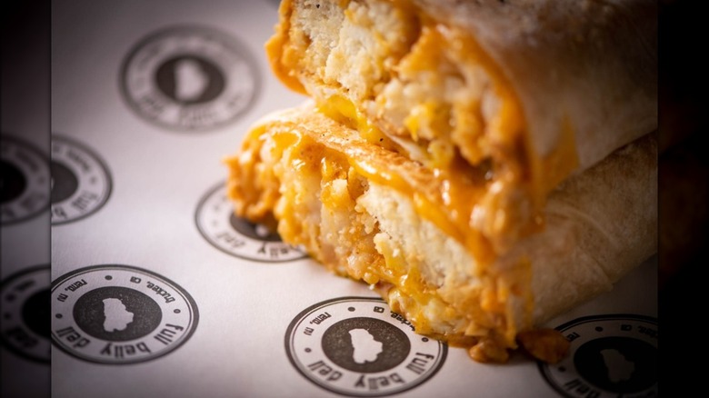 Two halves of the biscuits and gravy breakfast burrito