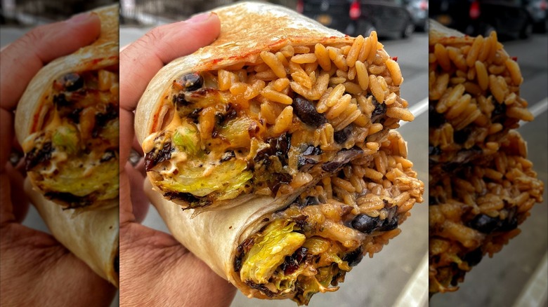 Two halves of a Brussels sprouts burrito with rice and beans