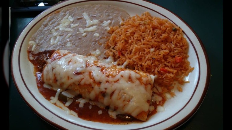 Plate with rice, beans, and wet burrito with cheese