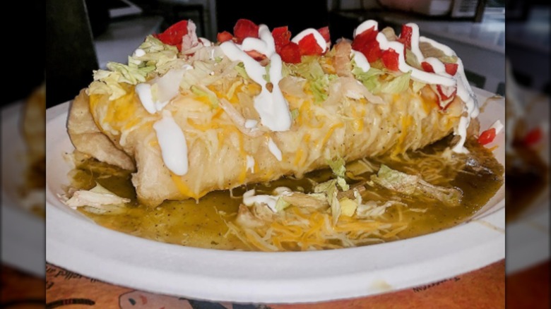Smothered burrito with sour cream and sauce