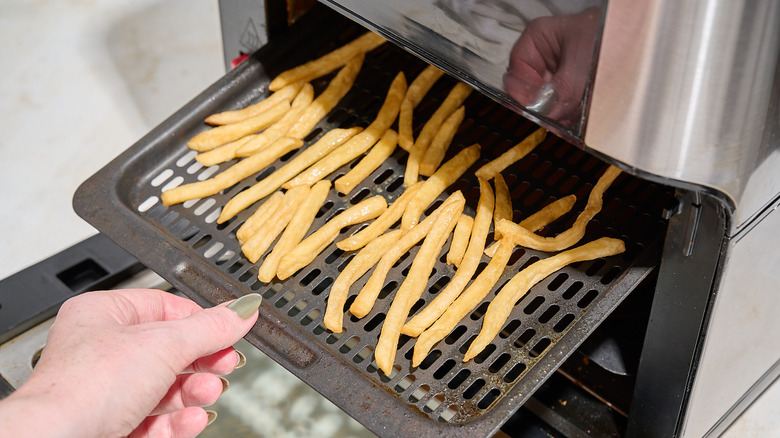 adding french fries to the air fryer