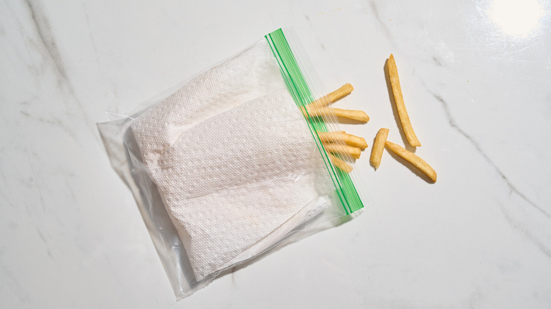 french fries in a bag with paper towel
