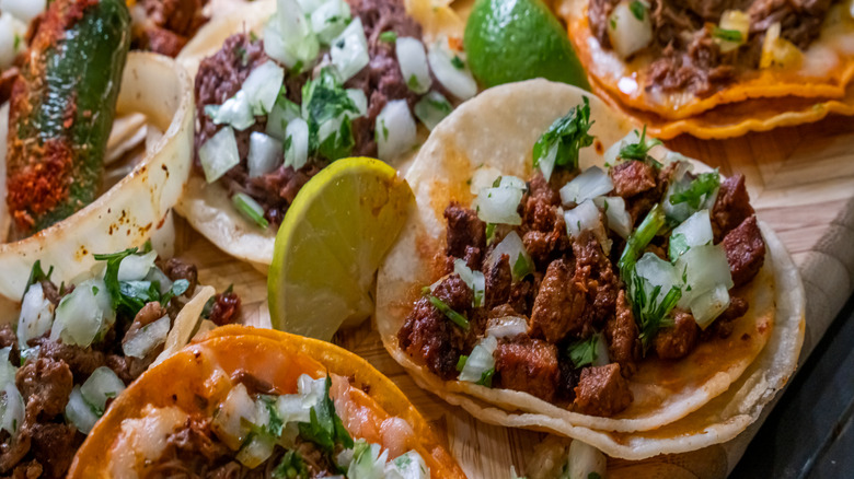 Street tacos on a wooden platter