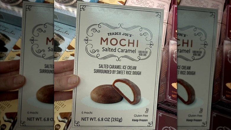 Woman holding bitten mochi box