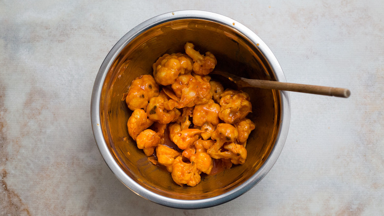 Buffalo cauliflower in mixing bowl