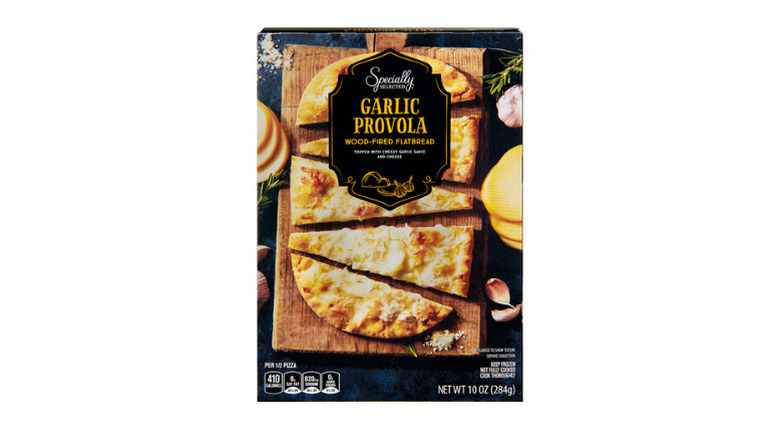 Box containing cheese and garlic flatbread against white background.
