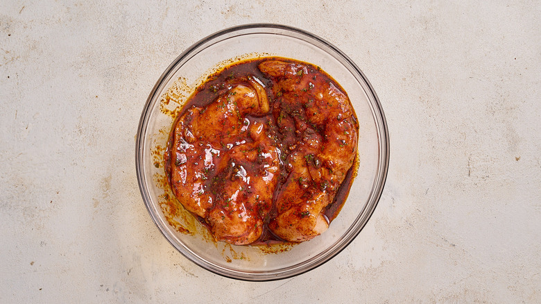 marinating chicken in a bowl