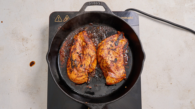 cooking chicken in a cast iron skillet