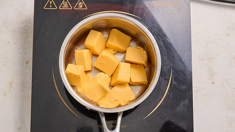cubed velveeta in a saucepan