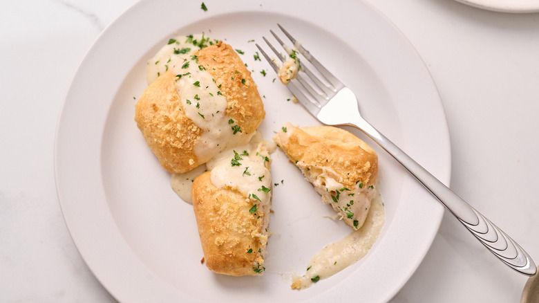 chicken pillow cut in half on a plate