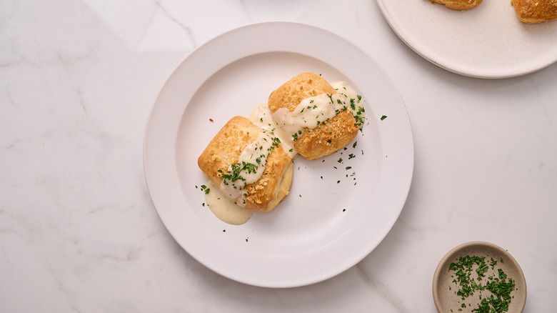chicken pillows on a plate with cream sauce