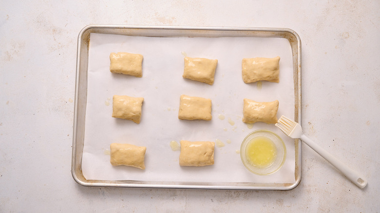 brushing chicken pillows with butter