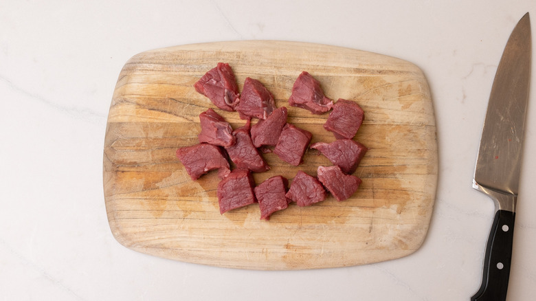 diced steak on chopping board