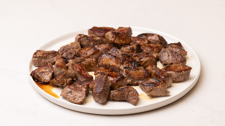 steak bites resting on plate