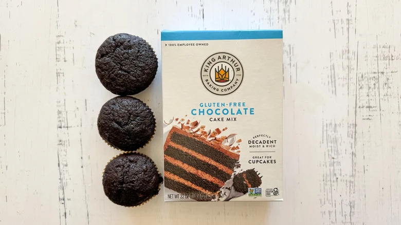 A box of King Arthur Baking Company Gluten-Free Chocolate Cake Mix next to three cupcakes