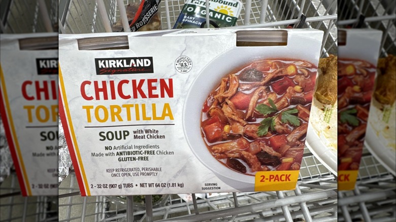 The Kirkland Signature chicken tortilla soup sitting in a shopping cart