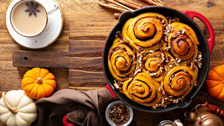 pumpkin spice cinnamon rolls with walnuts and cream