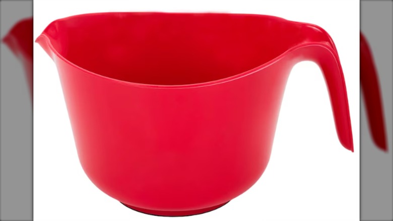 A red plastic mixing bowl with handle from Dollar Tree