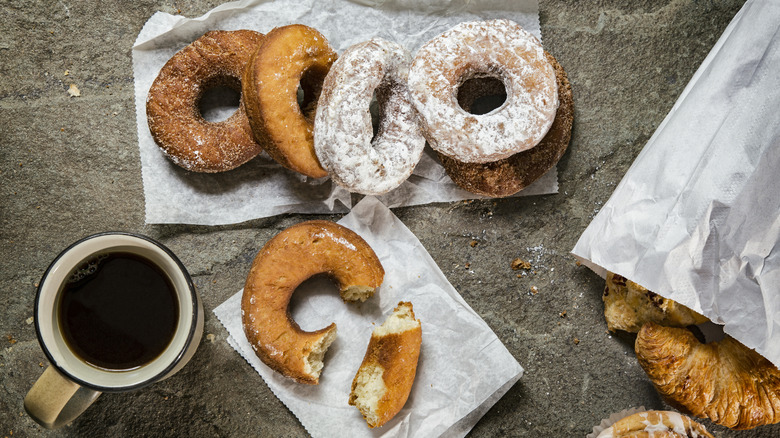 Various donuts and a coffee cup