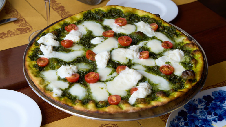 Pesto and fresh mozzarella pizza at Angelini Osteria